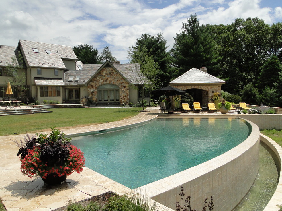 Pool fountain - large modern backyard stone and custom-shaped infinity pool fountain idea in Philadelphia