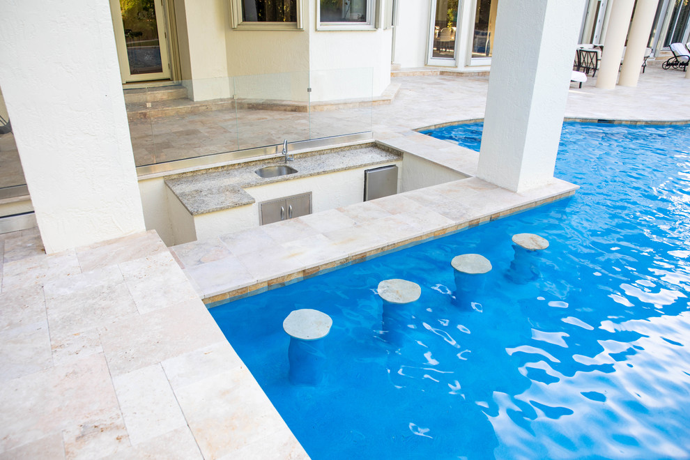 Immagine di un'ampia piscina a sfioro infinito minimalista personalizzata dietro casa con fontane e piastrelle