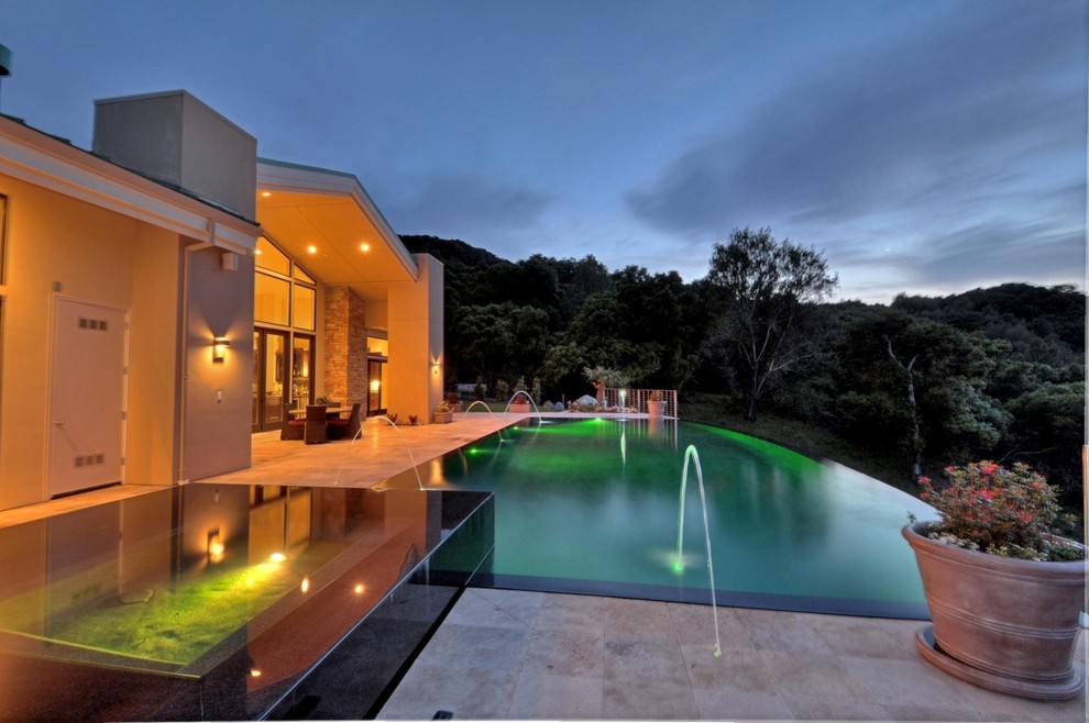 Inspiration for a mid-sized modern backyard stone and rectangular infinity pool fountain remodel in San Francisco