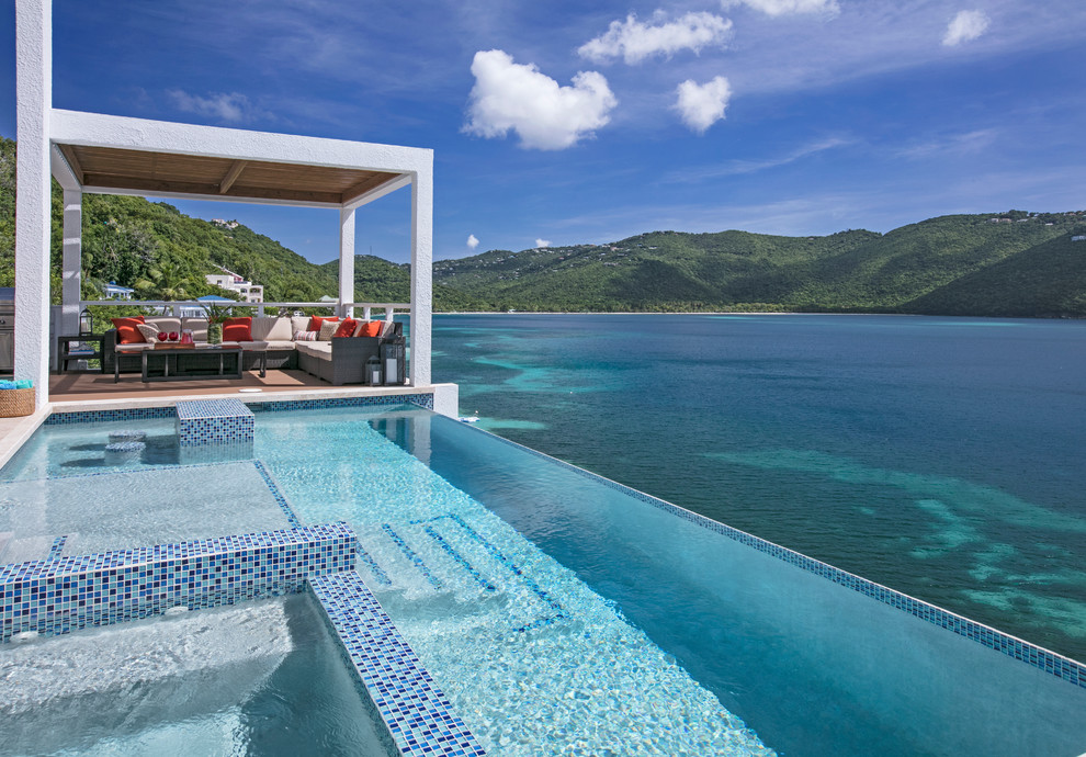 Infinity pool and outdoor seating in a cliffside St. Thomas vacation