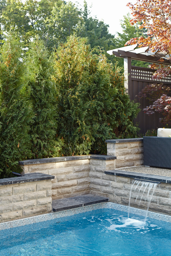 Inspiration for a small modern backyard stone and custom-shaped natural pool fountain remodel in Toronto