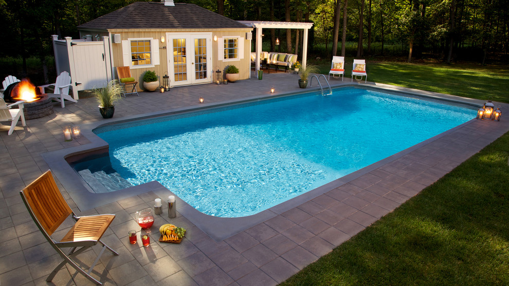 Inspiration for a large farmhouse back rectangular swimming pool in New York with a pool house and concrete paving.