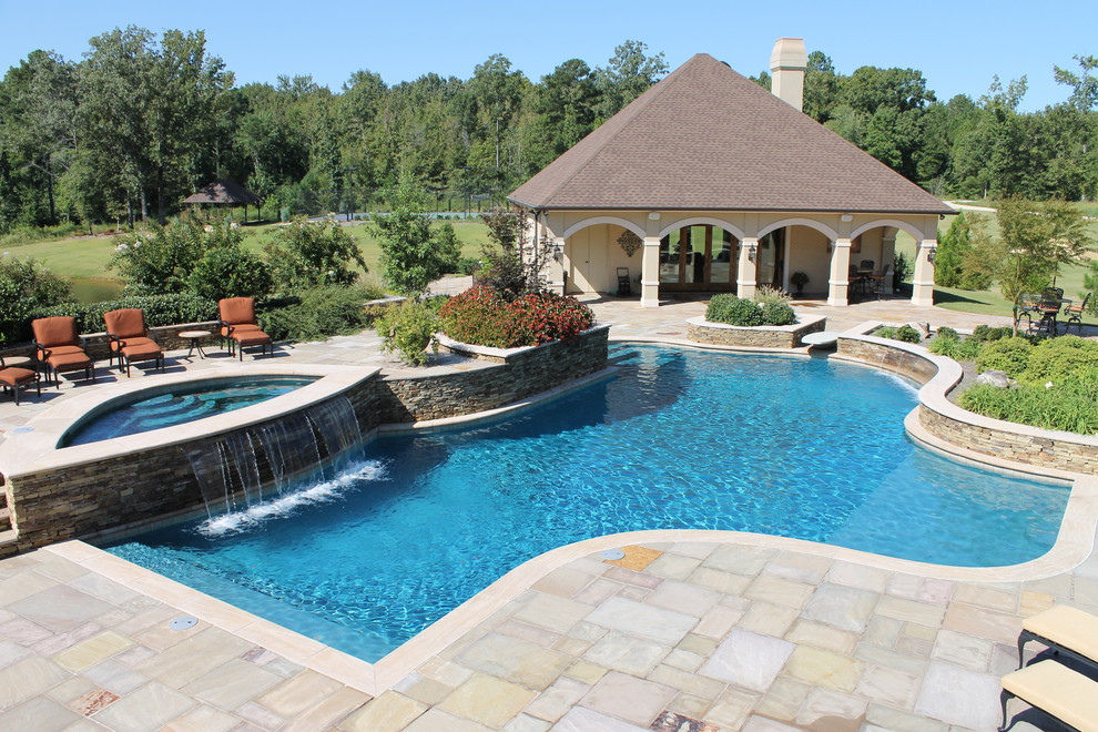 Imagen de piscina con fuente natural de estilo americano grande a medida en patio trasero con adoquines de piedra natural