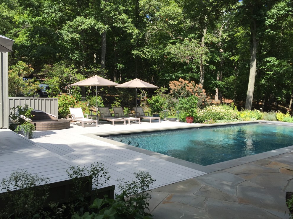 Ispirazione per una piscina design rettangolare di medie dimensioni e dietro casa con pavimentazioni in pietra naturale