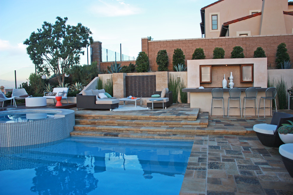 Contemporary back rectangular swimming pool in Orange County with a bar area.