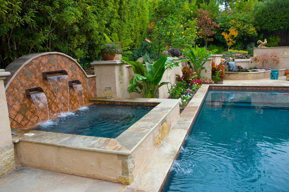 Mediterranean back rectangular swimming pool in San Francisco with a water feature.