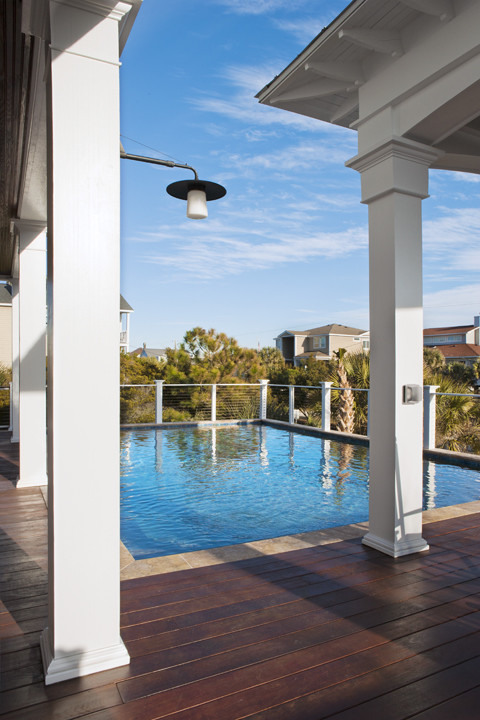 Mid-sized island style backyard rectangular lap pool photo in Charleston with decking