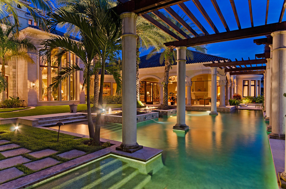 Pool - mediterranean backyard custom-shaped pool idea in Miami