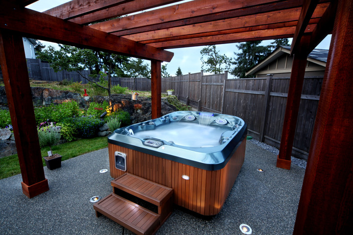This is an example of a small modern back custom shaped above ground hot tub in Las Vegas with decomposed granite.