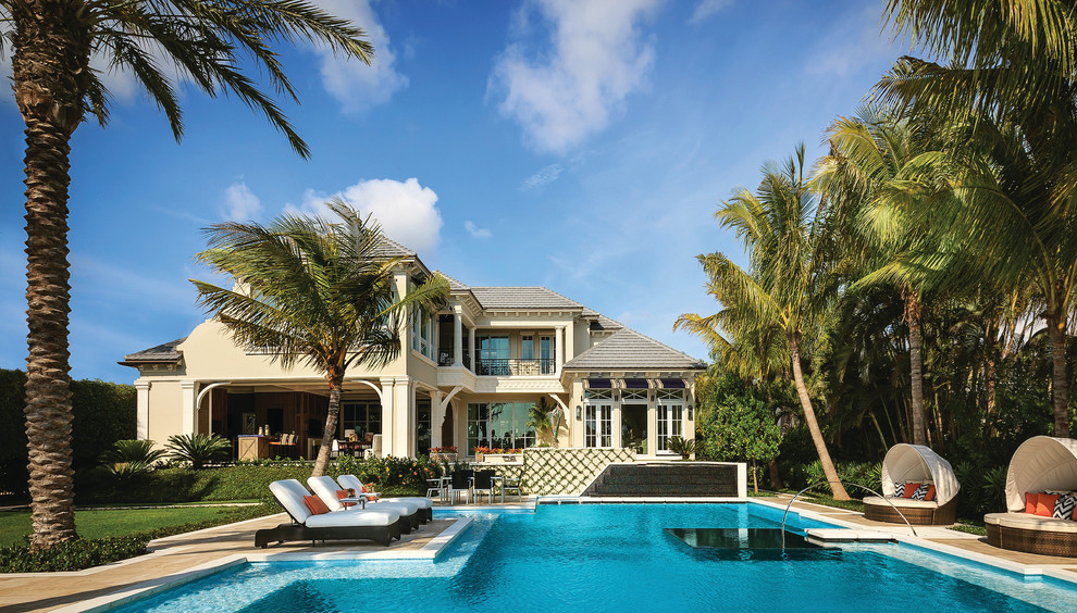 Inspiration for a back rectangular lengths swimming pool in Miami with natural stone paving.