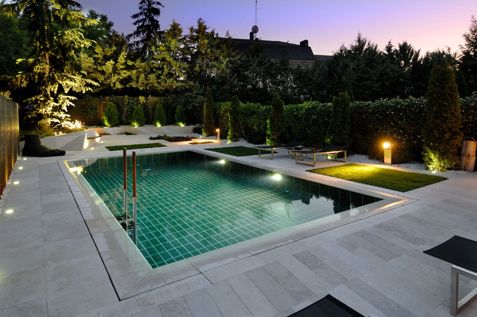 Inspiration for a medium sized traditional courtyard rectangular lengths swimming pool in Madrid with a pool house.