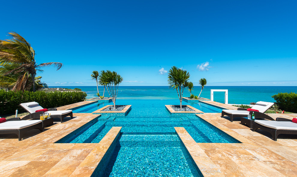 Island style custom-shaped infinity pool photo in Other