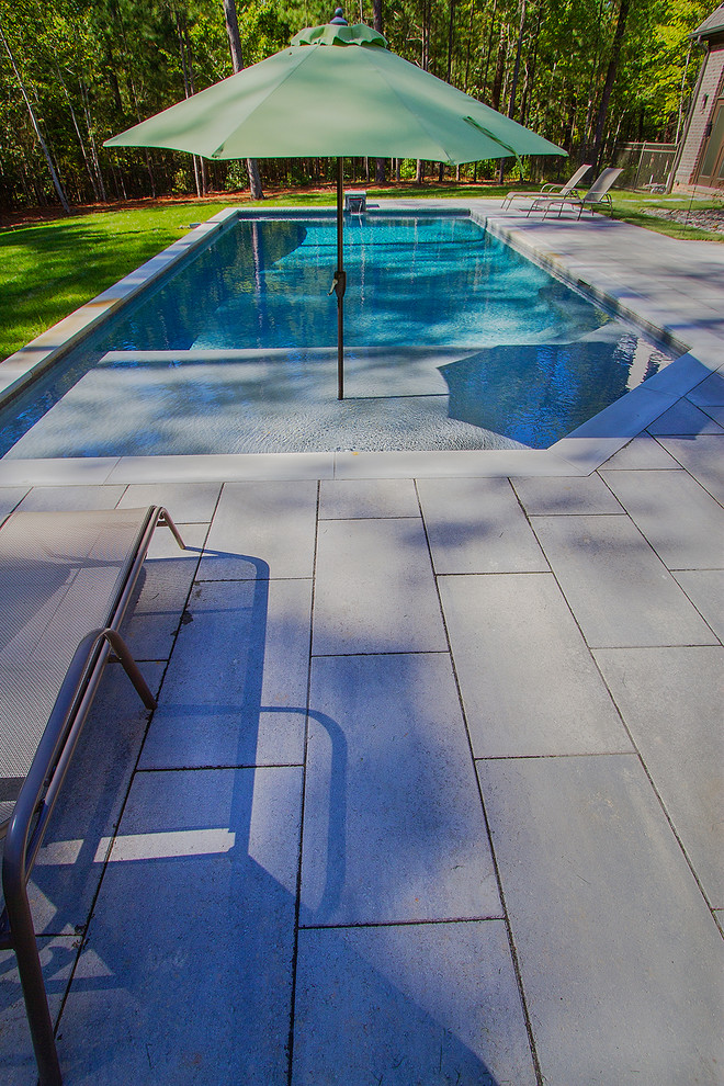Pool fountain - mid-sized contemporary backyard concrete paver and custom-shaped lap pool fountain idea in Raleigh