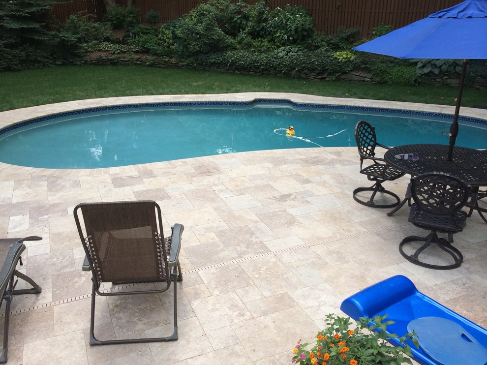 Inspiration for a large classic back custom shaped lengths swimming pool in DC Metro with concrete paving.