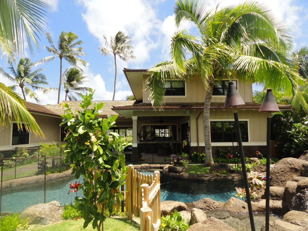 Hot tub - mid-sized tropical backyard stone and custom-shaped hot tub idea in Hawaii