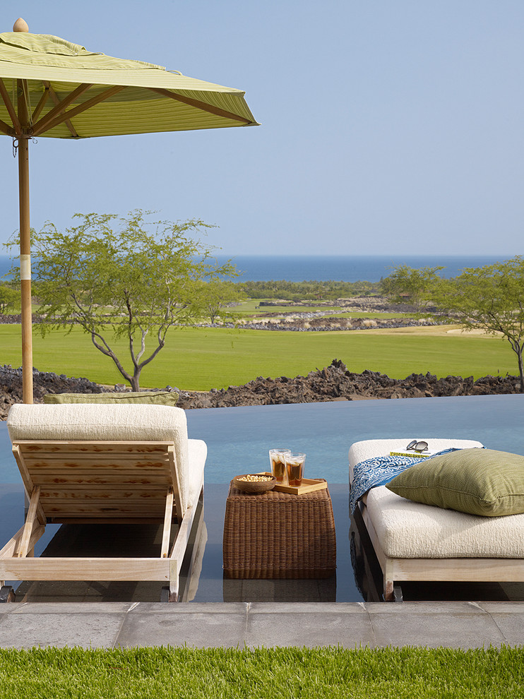 Example of a beach style infinity pool design in Hawaii