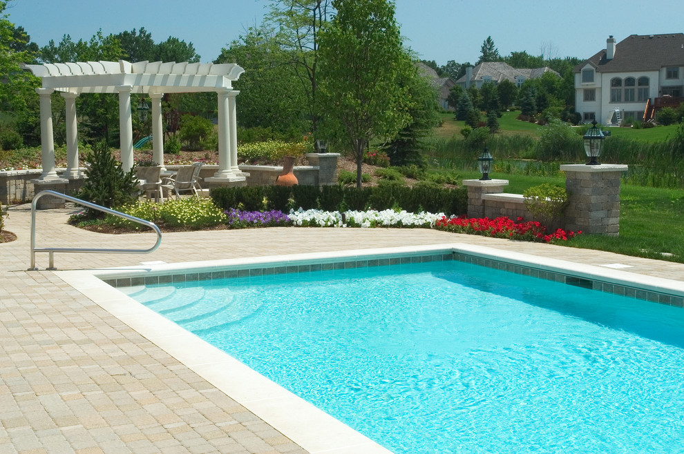 Inspiration for a small traditional back rectangular lengths swimming pool in Chicago with concrete paving.