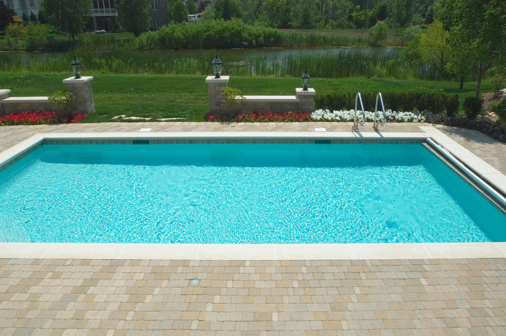 Inspiration for a small timeless backyard concrete paver and rectangular lap pool remodel in Chicago