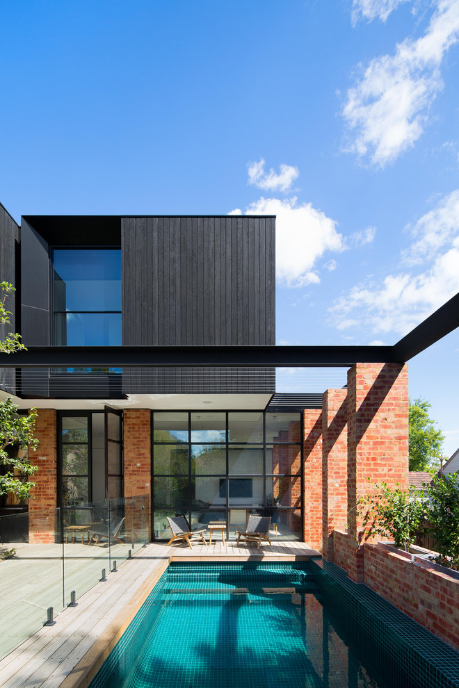 Photo of a contemporary rectangular swimming pool in Melbourne with decking.