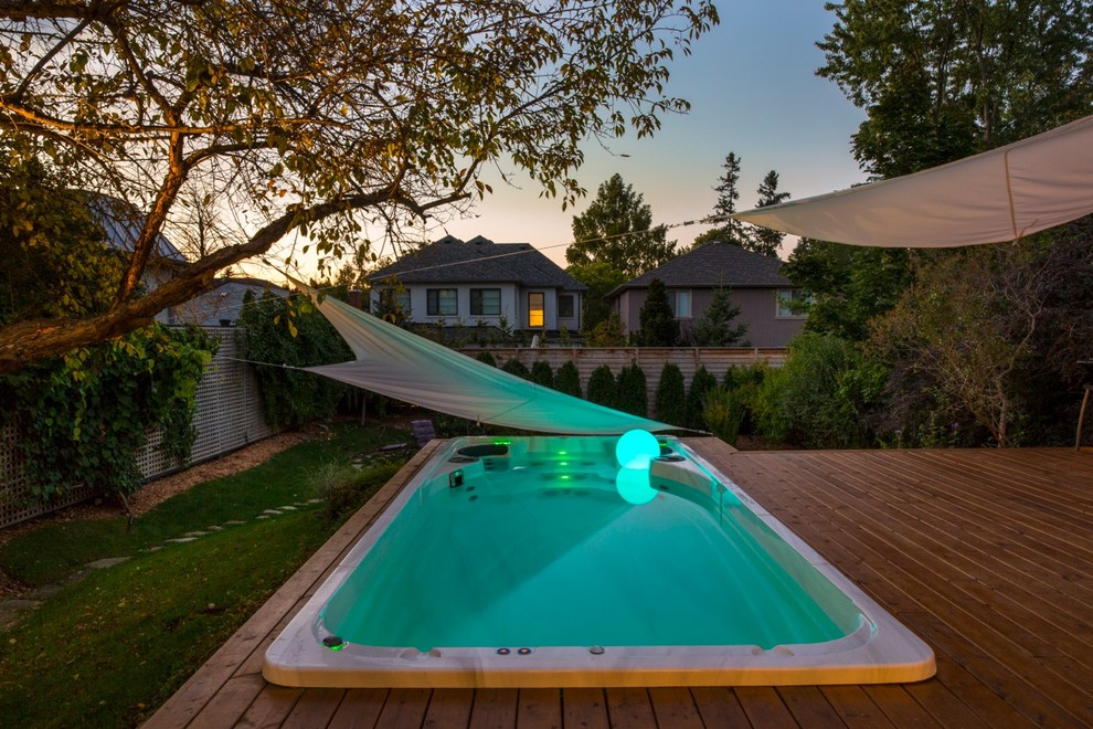 Idée de décoration pour une petite piscine hors-sol et arrière design rectangle avec un bain bouillonnant et une terrasse en bois.