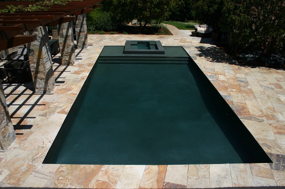 Pool fountain - large contemporary backyard stone and rectangular infinity pool fountain idea in Los Angeles