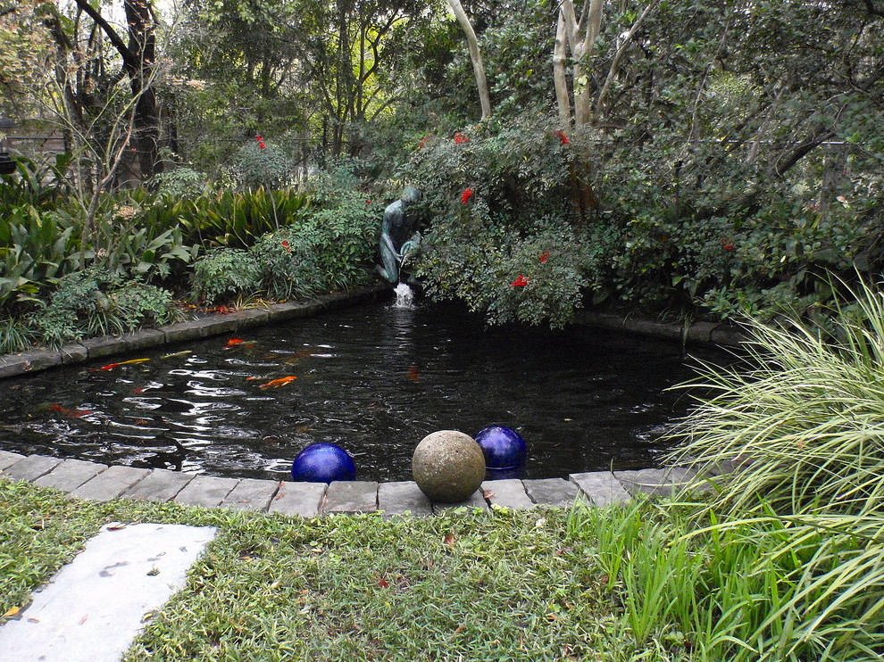 Idée de décoration pour un jardin arrière tradition de taille moyenne avec un point d'eau et des pavés en pierre naturelle.