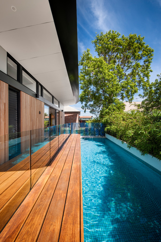 Small contemporary side rectangular lengths swimming pool in Adelaide with decking.