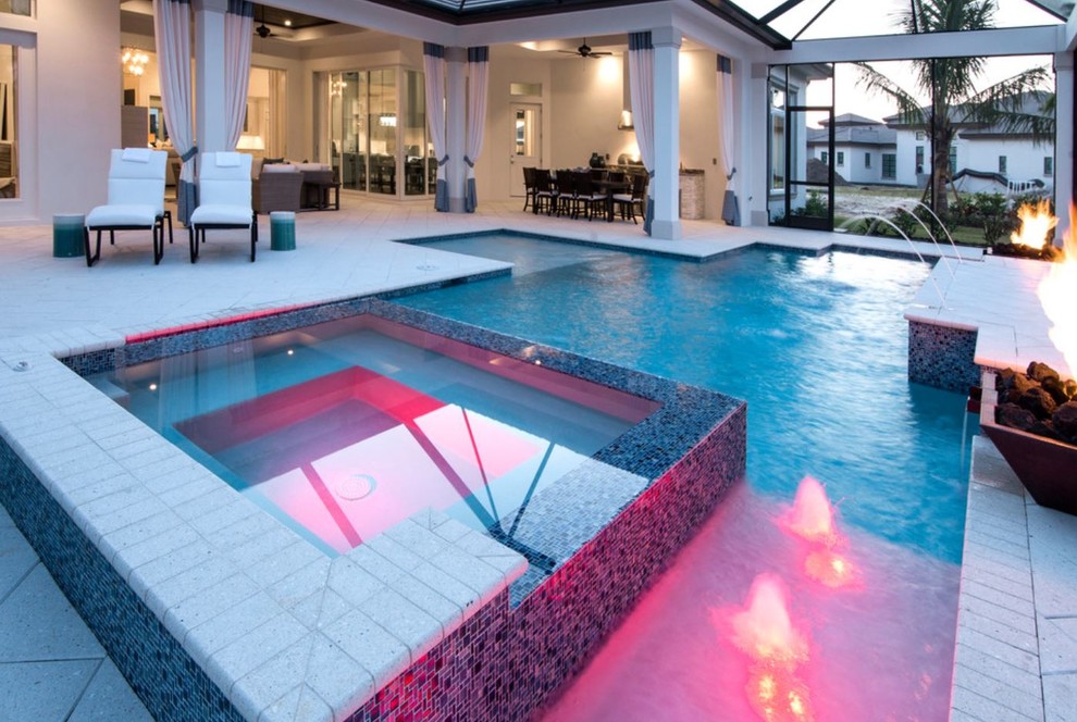 Large beach style backyard stone and custom-shaped lap hot tub photo in Miami