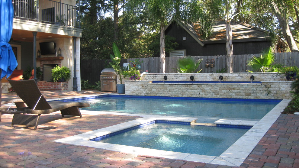 Inspiration for a mid-sized contemporary backyard concrete paver and rectangular natural hot tub remodel in New Orleans