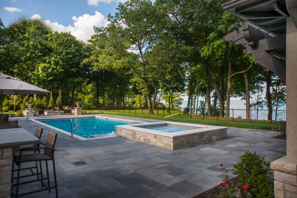 Inspiration for a medium sized classic back rectangular lengths hot tub in Chicago with natural stone paving.