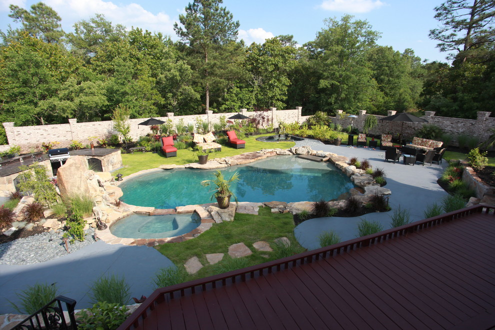 Inspiration pour une grande piscine naturelle et arrière bohème sur mesure avec un point d'eau et des pavés en pierre naturelle.