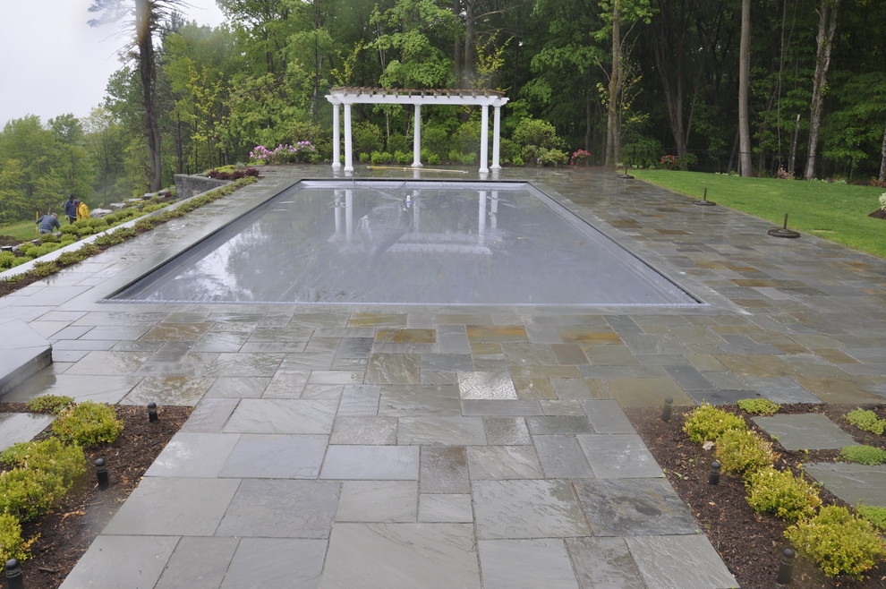 Inspiration for a large timeless backyard stone and rectangular natural hot tub remodel in Boston