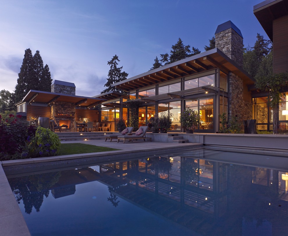 Inspiration for a large contemporary backyard concrete paver and rectangular lap hot tub remodel in Seattle