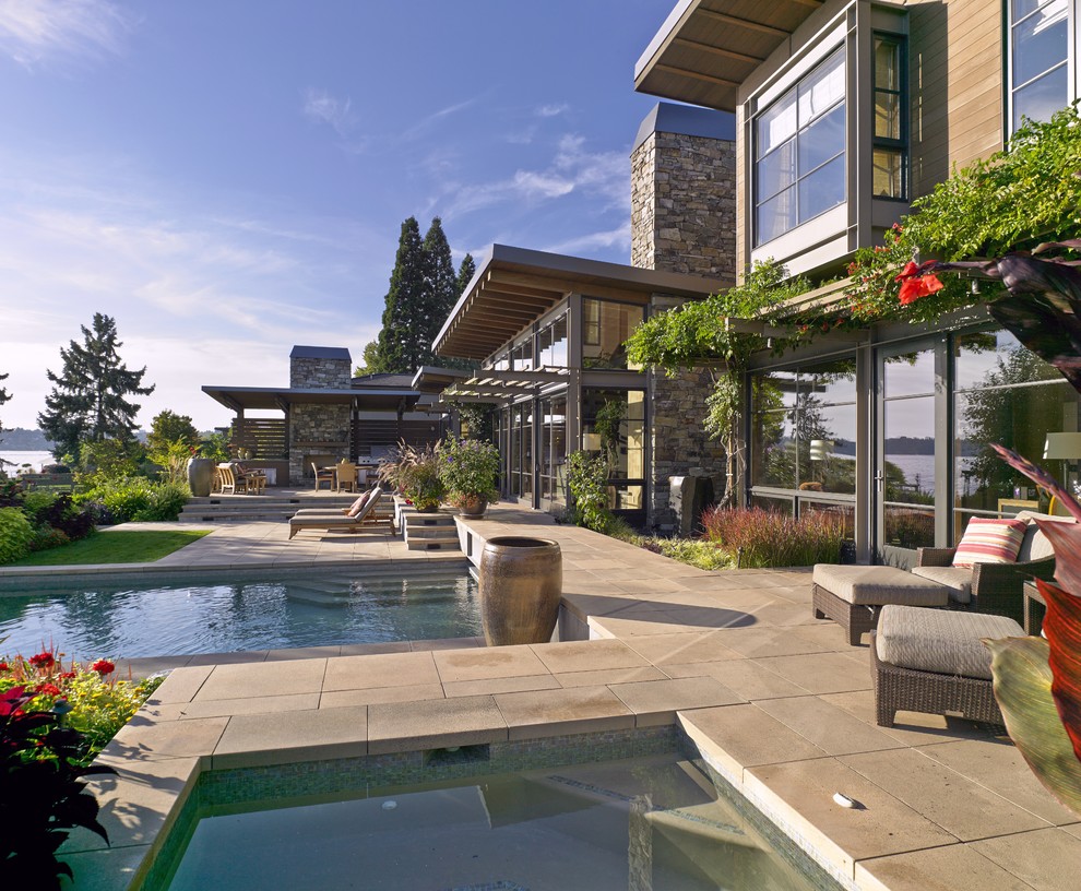 Example of a large trendy backyard concrete paver and rectangular lap hot tub design in Seattle