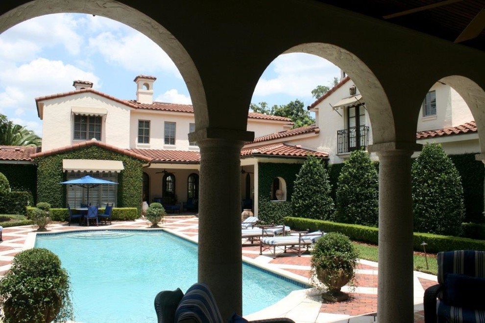 Großer Mediterraner Schwimmteich hinter dem Haus in rechteckiger Form mit Pflastersteinen in Orlando