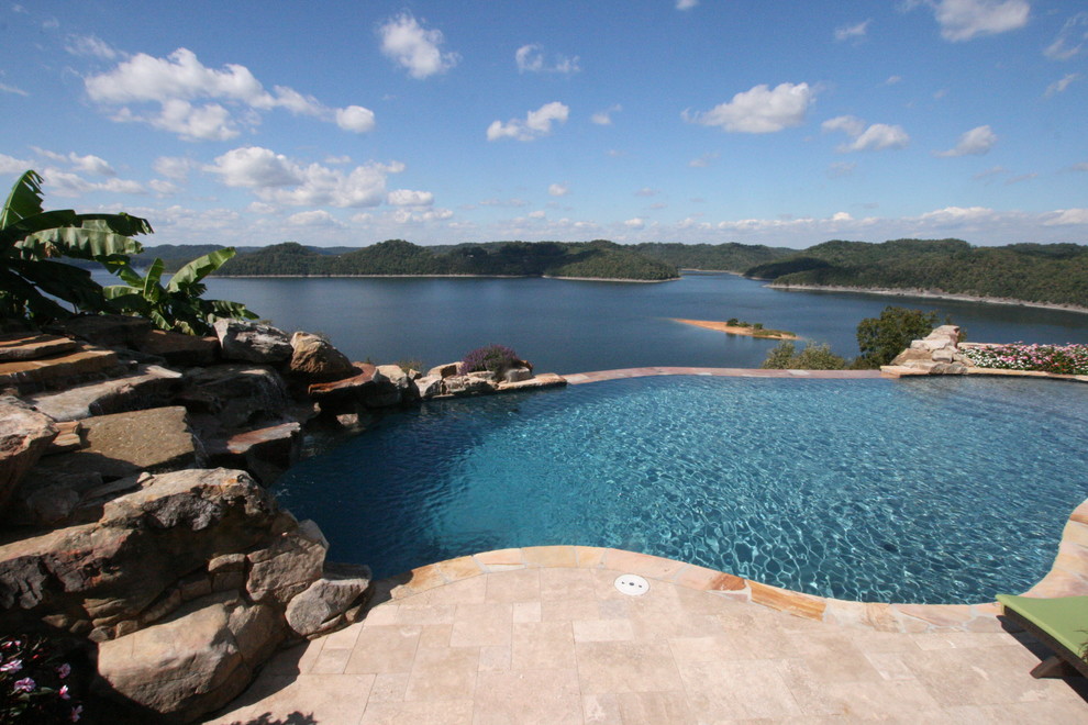 Inspiration for a large coastal backyard stone and custom-shaped infinity pool fountain remodel in Nashville