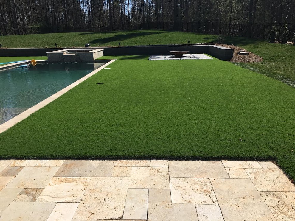 Imagen de piscinas y jacuzzis alargados actuales grandes rectangulares en patio trasero con adoquines de piedra natural