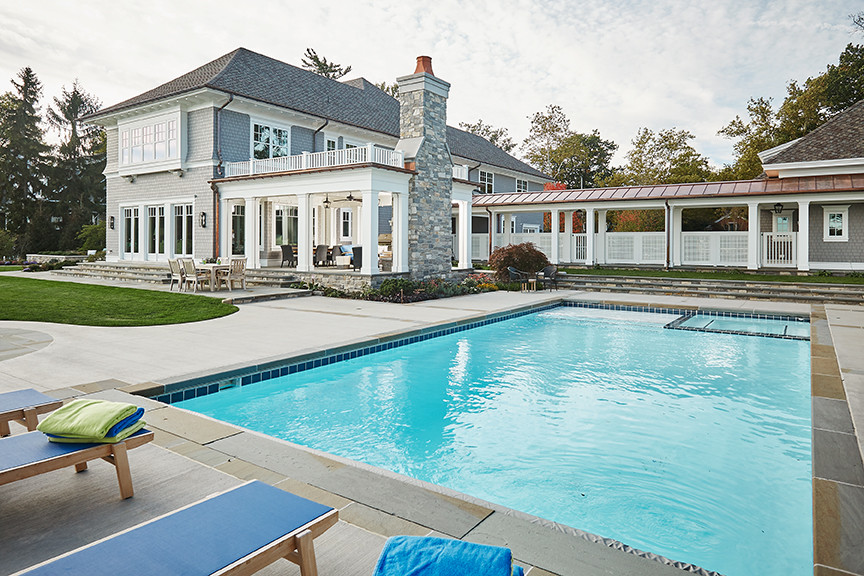 Inspiration for a mid-sized timeless backyard concrete paver and rectangular lap pool remodel in Grand Rapids