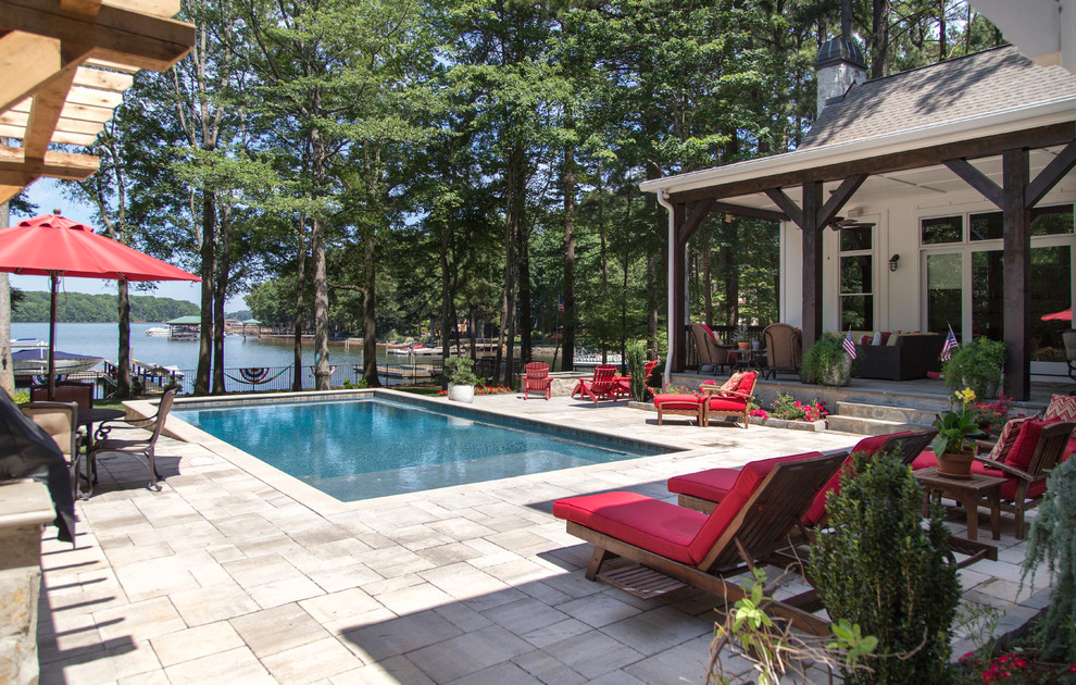 This is an example of a large country back rectangular lengths swimming pool in Charlotte with concrete paving.