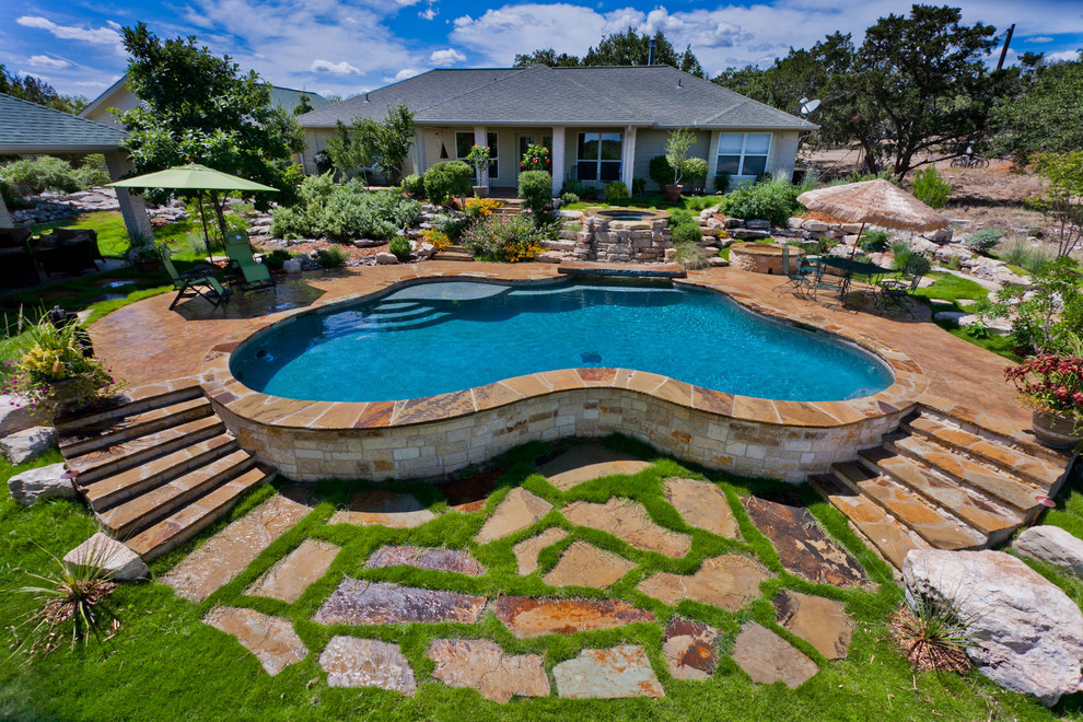 Example of a classic backyard custom-shaped pool design in Austin
