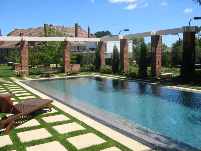 Imagen de piscina alargada clásica grande rectangular en patio trasero