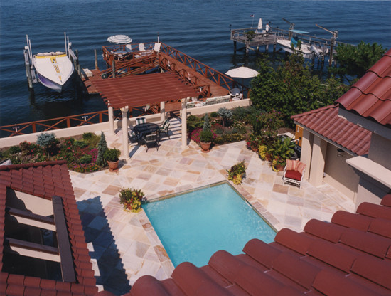 Photo of a medium sized mediterranean back rectangular lengths swimming pool in New York with a pool house and tiled flooring.