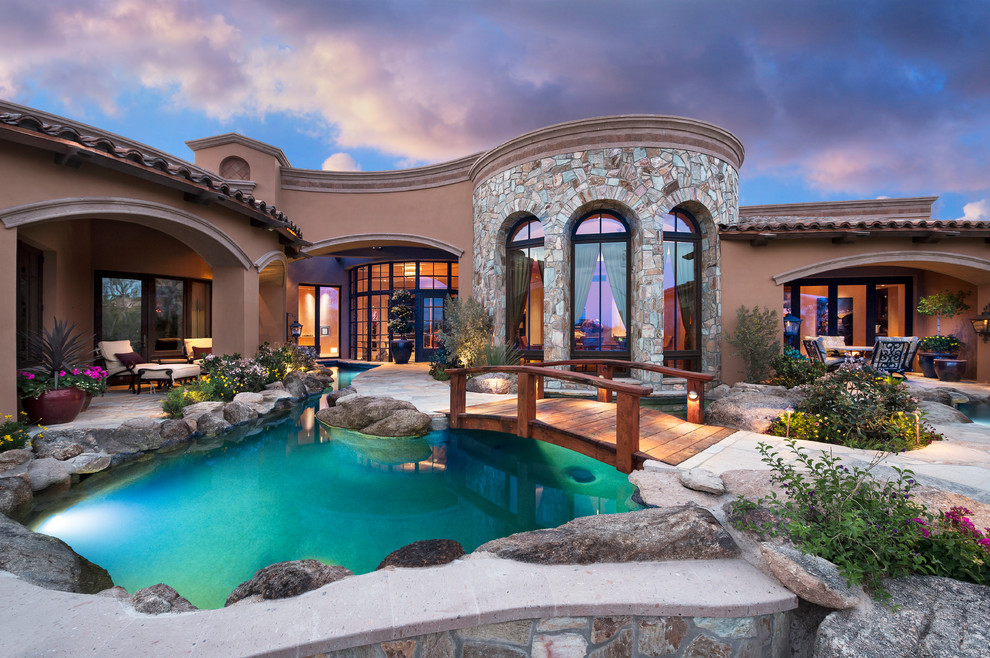 This is an example of a mediterranean custom shaped swimming pool in Phoenix.