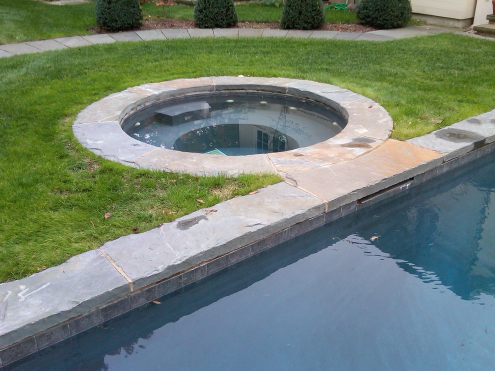 Источник вдохновения для домашнего уюта: прямоугольный бассейн среднего размера на заднем дворе в стиле фьюжн с джакузи и покрытием из каменной брусчатки