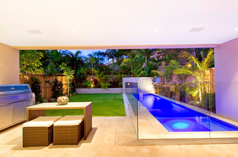 Design ideas for a small contemporary back rectangular lengths hot tub in Sydney with natural stone paving.