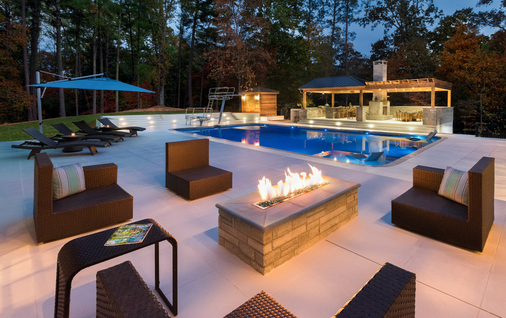 This is an example of a large contemporary rectangular swimming pool in Atlanta with tiled flooring and a pool house.