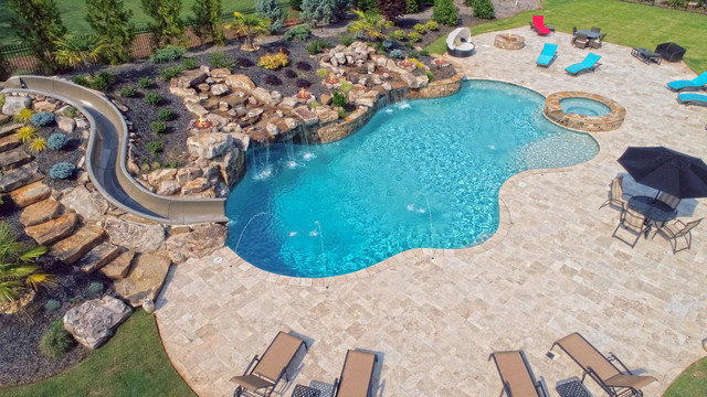 Large Custom Freeform Pool With Slide Grotto Waterfall And Travertine Swimming Pool Hot Tub By Aqua Design Pools Spas Llc Houzz Uk