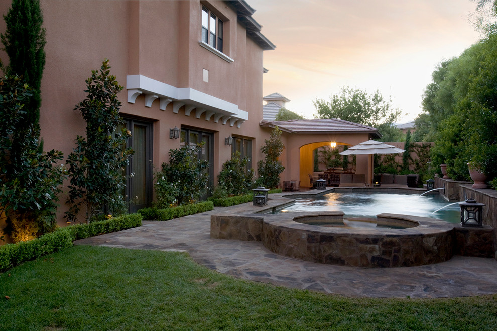 Design ideas for a mediterranean swimming pool in Las Vegas with natural stone paving.