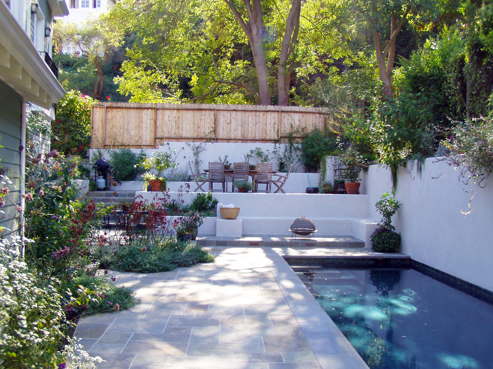 Pool fountain - mid-sized contemporary backyard stone and rectangular lap pool fountain idea in Los Angeles