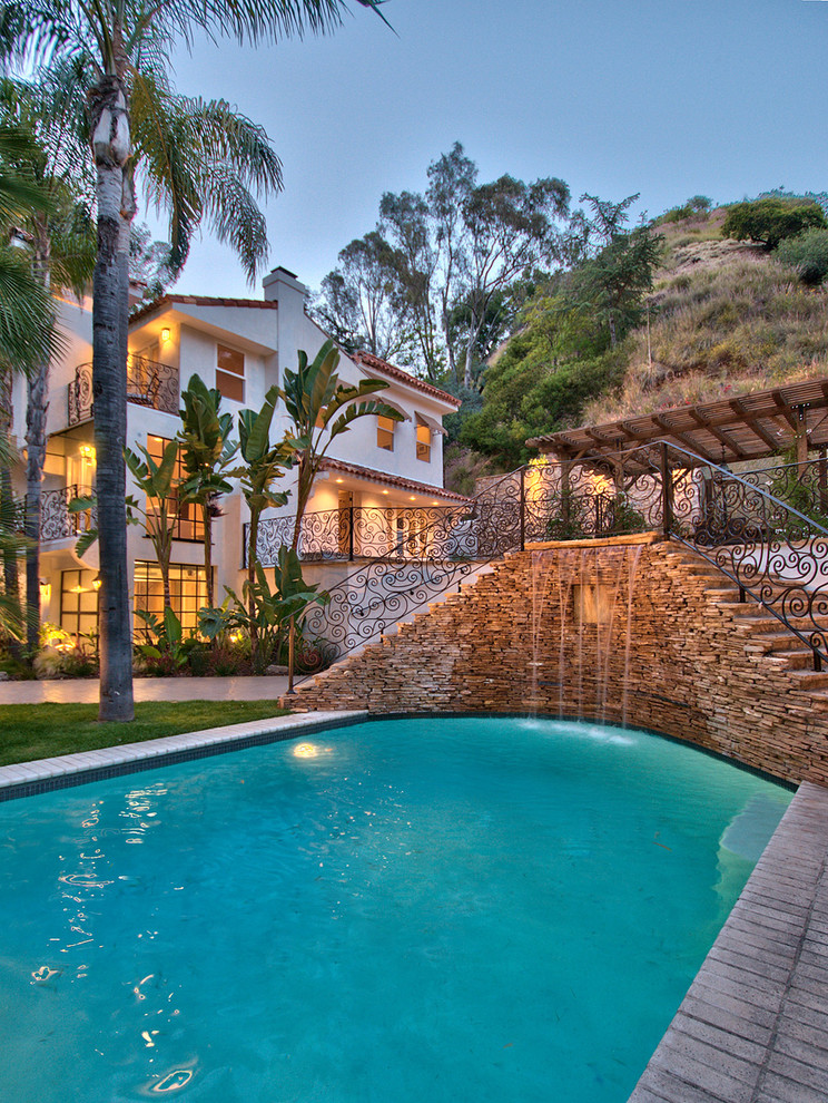 Large tuscan backyard custom-shaped pool photo in Los Angeles